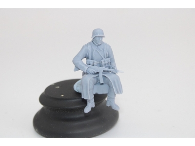 German Soldier Sitting In Greycoat With Sturmgwehr 44 - image 1