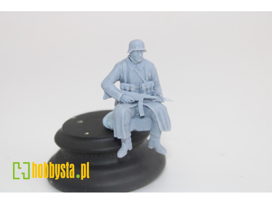 German Soldier Sitting In Greycoat With Sturmgwehr 44 - image 1