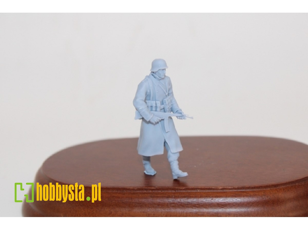 German Soldier Walking In Greycoat With Steelhelmet And Sturmgewehr 44 - image 1
